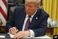 President Donald Trump signs an executive order on birthright citizenship in the Oval Office of the White House, in Washington, Jan. 20, 2025.