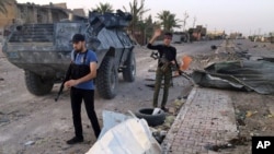 Iraqi security forces and tribal fighters regain control of northern neighborhoods after overnight heavy clashes with Islamic State militants in Ramadi, April 23, 2015. 
