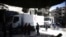 People are seen around Red Crescent aid truck in the besieged town of Douma, Eastern Ghouta, in Damascus, Syria, March 9, 2018.