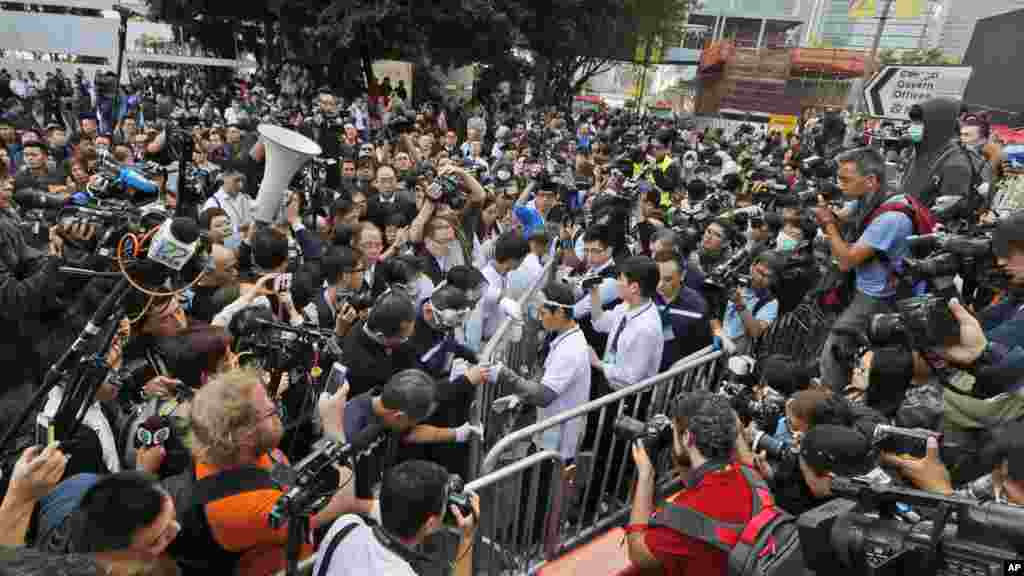 Workers, center, start clearing away barricades at an occupied area outside government headquarters in Hong Kong, Nov. 18, 2014. 