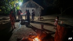 Juma Indigenous women prepare the day’s catch in their community, near Canutama, Amazonas state, Brazil, July 8, 2023.