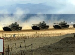 FILE - Taiwan Army U.S.-made M-48 tanks take part in a live fire exercise on the southern Pingtung sea front, April 20, 2001.