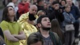 Evacuated residents look at their multi-story apartment building which was damaged during Russian attack in Kyiv, Ukraine, May 30, 2023. 