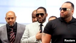 FILE PHOTO: R. Kelly walks inside the Criminal Court Building as he arrives for a hearing on eleven new counts of criminal sexual abuse, in Chicago, Illinois, U.S., June 6, 2019.