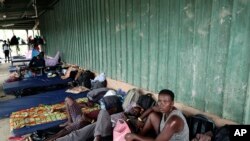 Migrants from several African countries rest outside a barn used as a shelter in Peñitas, Darien Province, Panama, May 10, 2019. African and Asian migrants tend to pay smugglers to shepherd them through the Darien Gap on their journey north to the U.S.