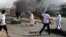 Protesters burn tires amid a wave of unrest over the lifting of fuel subsidies by the Sudanese government, in Kadro, 25 kilometers north of downtown Khartoum, September 25, 2013.
