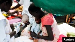 FILE - A medical staff attends to a malnourished child at a Medecins Sans Frontieres hospital in a displaced-persons camp inside the U.N. base in Malakal, South Sudan, July 24, 2014. 