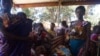 FILE - Some women in Malawi have had their uteruses involuntarily removed soon after giving birth in procedures that have come under scrutiny. Pictured here are mothers attending a clinic with their children the at Likuni clinic in the capital Lilongwe.