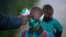FILE - A boy's temperature is checked as he enters a school amid the coronavirus pandemic, in Johannesburg, South Africa, July 7, 2020.