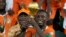 Ivory Coast captain Max-Alain Gradel and President Alassane Ouattara raise Africa Cup of Nations trophy after winning the final against Nigeria, at the Olympic Stadium of Ebimpe in Abidjan, February 11, 2024.