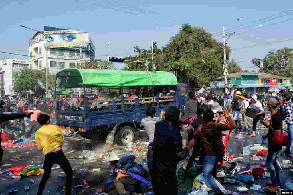 Demonstrators clash with riot police during a protest against the military coup in Mandalay, Myanmar, Feb. 9, 2021.