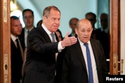 Russian Foreign Minister Sergei Lavrov and his French counterpart Jean-Yves Le Drian arrive for a meeting of the Russian-French Security Cooperation Council in Moscow, Russia, Sept. 9, 2019.