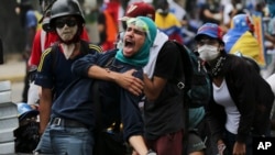 An anti-government protester screams at security forces blocking a march to the Supreme Court to oppose President Nicolas Maduro's plan to rewrite the constitution, in Caracas, Venezuela, July 22, 2017. 