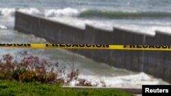 A police cordon tape is seen near the beach and the Mexico-U.S. border fence, after municipal beaches are closed as part of social distancing measures to control the spread of he coronavirus disease (COVID-19), in Tijuana, Mexico March 30, 2020.