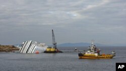 An oil recovery sea platform is seen next to the Costa Concordia cruise ship off the west coast of Italy, at Giglio island, January 26, 2012.