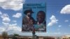 A billboard in South Sudan's capital Juba on April 15, 2016 shows South Sudan's President Salva Kiir (L), and rebel leader Riek Machar (R), who is scheduled to return to the city and assume the vice presidency on Monday. (VOA/J. Patinkin)