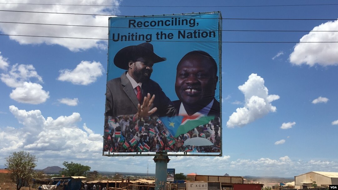 A billboard in South Sudan's capital Juba on April 15, 2016 shows South Sudan's President Salva Kiir (L), and rebel leader Riek Machar (R), who is scheduled to return to the city and assume the vice presidency on Monday. (VOA/J. Patinkin)
