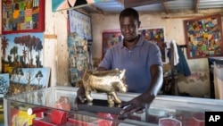 Jeweller Moussa Diop presents a bronze hippopotamus in his workshop, as part of the rebondir exhibition at the Dakar 2024 biennial Off in Dakar, Senegal, Nov. 28, 2024.