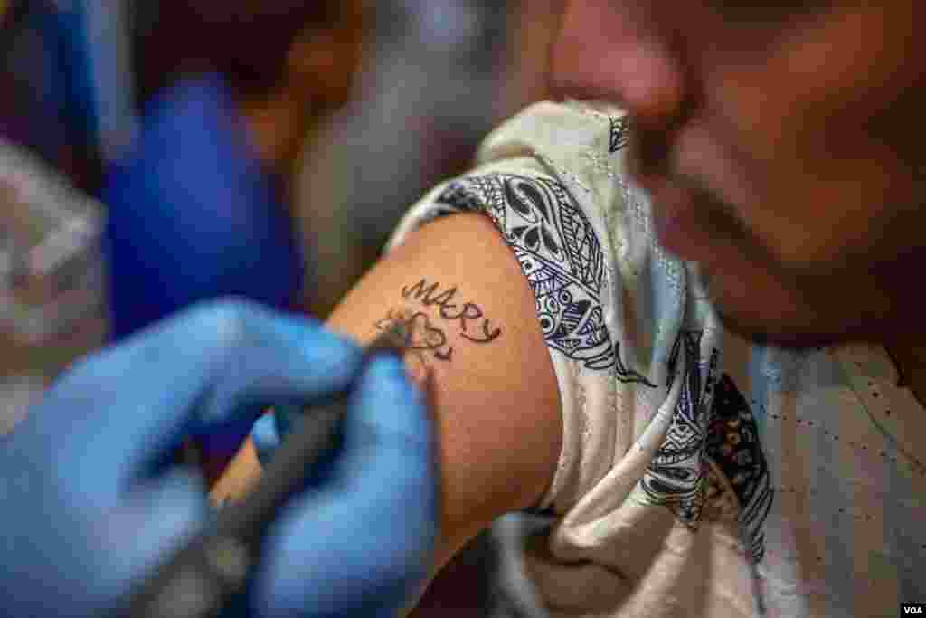 Adults are getting tattoos during the season of celebrations in August to show devotion to the Virgin Mary. Sunday, August 18, 2019.