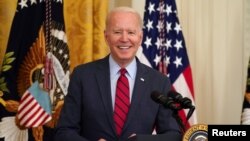 U.S. President Joe Biden smiles as he delivers remarks on the bipartisan infrastructure deal in the East Room of the White House in Washington, June 24, 2021. 