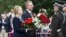U.S. Secretary of State Hillary Rodham Clinton pays her respects at the Freedom Monument with Latvian Foreign Minister Edgar Rinkevics in Riga, Latvia, June 28, 2012.