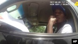 This photo taken from a body camera on June 9, 2017, shows tennis star Venus Williams listening to Palm Beach Gardens Police Officer David Dowling following a car crash in Palm Beach Gardens, Florida.