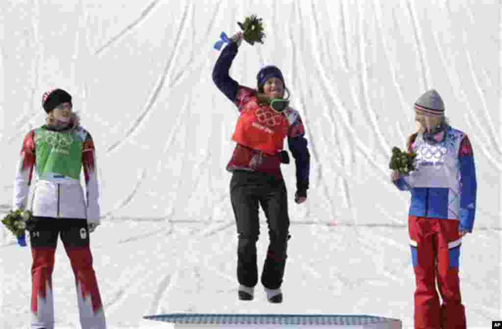 Czech Republic's Eva Samkova, center, celebrates after taking the gold medal in the women's snowboard cross final, ahead of silver medalist Dominique Maltais of Canada, left, and bronze medalist France's Chloe Trespeuch at the Rosa Khutor Extreme Park, at