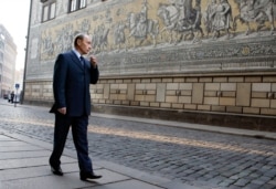 FILE - Russian President Vladimir Putin walks around the city during a visit to Dresden, Germany, Oct. 11, 2006. Putin was stationed in Dresden, then part of East Germany, as a KGB officer from 1985 to 1990.