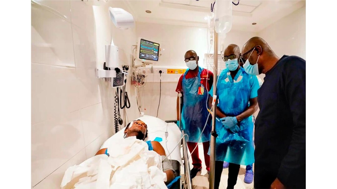 In this photo released by the Lagos State government press, governor Babajide Sanwo-Olu, right, visit victims injured in last night's protests in a hospital in Lagos, Nigeria, Oct. 21, 2020.