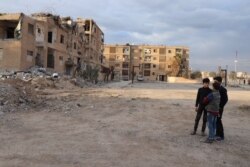When Islamic State militants were defeated, they left behind half-destroyed buildings now housing displaced families from Idlib, in Raqqa, Syria, Feb. 23, 2020. (Heather Murdock/VOA)