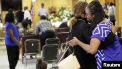 FILE - Waltrina Middleton (R), cousin of shooting victim DePayne Doctor, embraces Claudia Lawton in the basement where a mass shooting occurred at the Emanuel A.M.E. Church four days earlier, in Charleston, South Carolina, June 21, 2015. 