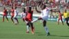 FILE - Malawi, in red, plays against Guinea during the Africa Cup of Nations qualifiers at Kamuzu Stadium in Blantyre in 2016. (Photo courtesy of Patrick Lunda)