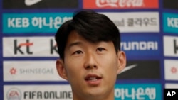 South Korean national soccer team player Son Heung-min answers a reporter's question upon his arrival after the soccer match against North Korea, at Incheon International Airport in Incheon, South Korea, Thursday, Oct. 17, 2019.