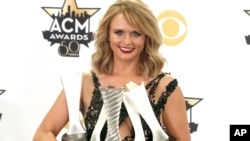 Miranda Lambert poses in the press room with the milestone award and the awards for song of the year for "Automatic", album of the year for "Platinum" and female vocalist of the year at the 50th annual Academy of Country Music Awards at AT&T Stadium, April 19, 2015, in Arlington, Texas. 