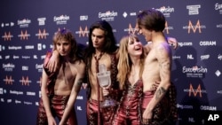 Members of the band Maneskin, from left, Thomas Raggi, Ethan Torchio, Victoria De Angelis and Damiano David pose with the trophy after winning the Grand Final of the Eurovision Song Contest in Rotterdam, Netherlands, May 22, 2021.