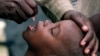 In this file photo taken on Jan. 25, 2002, a Congolese child is given a polio vaccination at a relief camp near Gisenyi, Rwanda. 