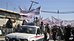 Pakistani tribesmen hold banners during a protest demanding an end to the U.S. drone strikes (file photo)