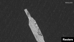 A closeup of the Iranian mockup aircraft carrier is seen in this satellite image collected over the Strait of Hormuz, July 28, 2020, by Maxar. 