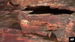 A layer of bright catlinite, the unique variety of soft pipestone used by Native Americans to carve pipes, is seen at the Pipestone National Monument on Wednesday, May 3, 2023, in Pipestone, Minn. (AP Photo/Jessie Wardarski)