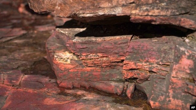 A layer of bright catlinite, the unique variety of soft pipestone used by Native Americans to carve pipes, is seen at the Pipestone National Monument on Wednesday, May 3, 2023, in Pipestone, Minn. (AP Photo/Jessie Wardarski)