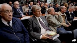Jorge Eduardo Acosta, left, a former navy captain; Alfredo Astiz, second left, a former navy spy nicknamed "the Angel of Death;" and other former members of the Argentine armed forces sit in a courtroom in Buenos Aires, Argentina, Nov. 29, 2017. Acosta and Astiz were sentenced to life in prison.