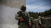 FILE - Mexican Army soldiers stand guard in Chiapas state, Mexico, Aug. 3, 2021. Four people died after Mexican army troops opened fire on a truck carrying migrants on Oct. 1, 2024, according to an official.