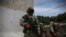FILE - Mexican Army soldiers stand guard in Chiapas state, Mexico, Aug. 3, 2021. Four people died after Mexican army troops opened fire on a truck carrying migrants on Oct. 1, 2024, according to an official.