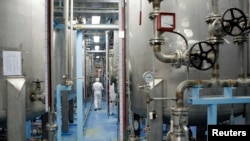 FILE - A technician is seen at the uranium conversion facility in Isfahan, 450 kilometers south of Tehran, February 3, 2007. 