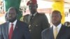 South Sudanese President Salva Kiir (left) watches an Independence Day parade in Juba on July 9, 2014 with Ugandan President Yoweri Museveni (right). 