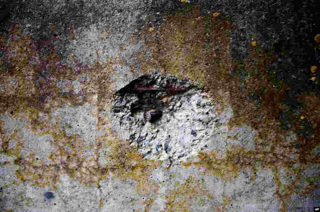 A bullet fired by South Ossetian forces remains stuck in the wall of an abandoned house. (Yuli Weeks for VOA)