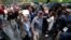 Voters are applauded as they leave a polling station for the banned independence referendum in Barcelona, Spain, Oct. 1, 2017. 