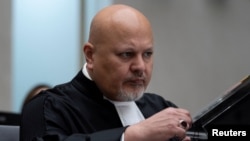 FILE: Public Prosecutor Karim Khan prepares for the trial of Mahamat Said Abdel Kani at the International Criminal Court in The Hague, Netherlands, Monday, Sept. 26, 2022.