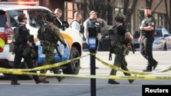 Police deploy at the scene of a mass shooting near Slugger Field baseball stadium in downtown Louisville