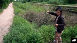 FILE - Sok Koeun, a villager who lives along the Funan Techo Canal, collects firewood for cooking at her home at Prek Takeo village, eastern Phnom Penh, Cambodia, July 30, 2024. 